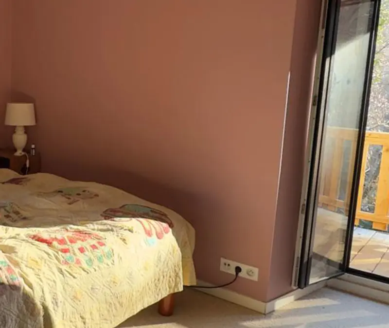 Bright bedroom with a balcony overlooking the valley